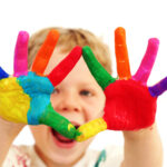 Happy child with painted hands